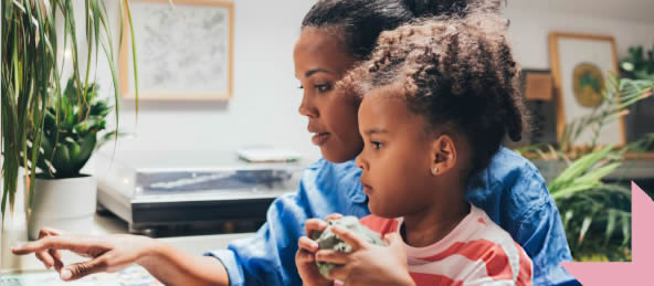 lady and little girl looking at a laptop